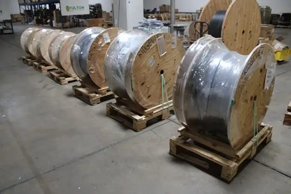 large spools of cable in a warehouse