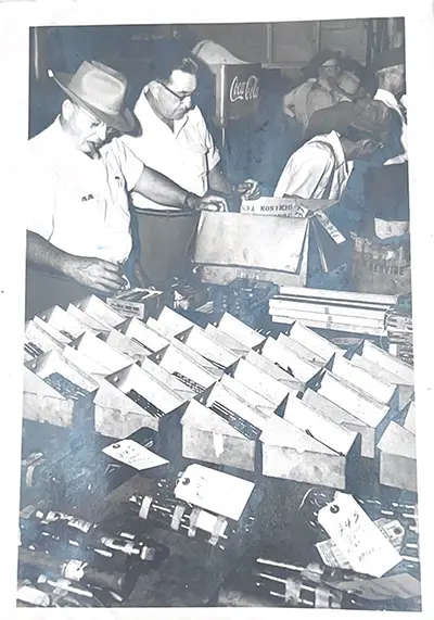 vintage photo of auction-goers browsing items